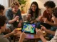 Friends enjoying Tiranga Games on a tablet in a cozy living room, showcasing excitement and camaraderie.